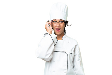 Young chef Argentinian woman over isolated background with glasses and surprised