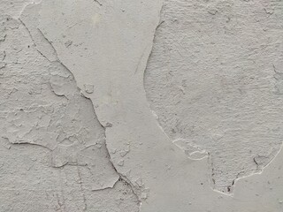 Aged plaster wall with cracks and peeling layers