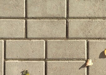 Beige brick pavement texture with small debris
