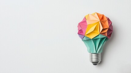 A colorful origami light bulb design, symbolizing creativity and innovation, set against a minimalist background.