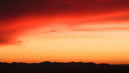 Obraz premium Fiery Sunset Over Silhouetted Mountains Dramatic Sky Landscape Photography