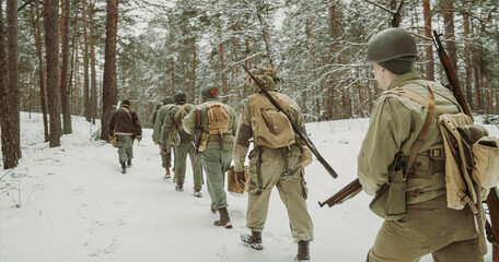 American Infantry Soldier Going Through Forest Road In Cold Winter Day. Usa Soldier Marching By...