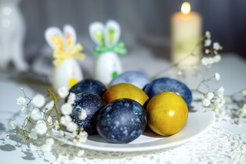 Easter eggs, blue, olive, hibiscus tea, gypsophila, white flower, white plate, white surface, candle