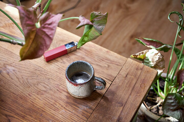 there's a cup of coffee on the table with a red lipstick imprint on it