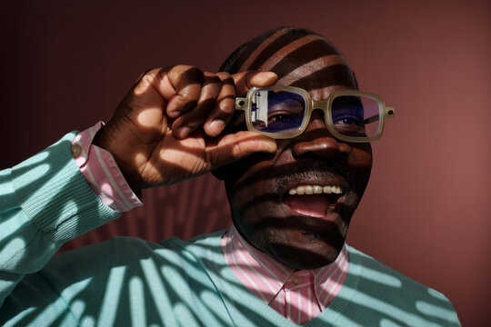 Smiling African American Man in Shadowed Lighting