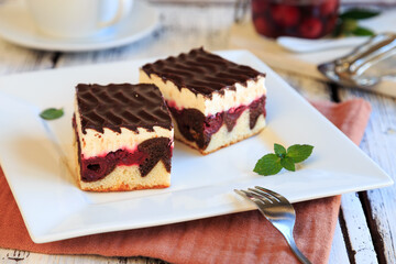 chocolate-covered cake with vanilla pudding and sour cherries