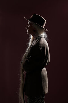 Profile of Elderly Woman Wearing Wide-Brimmed Hat