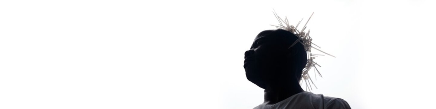 Silhouette of Person with Spiky Hair Against White Background