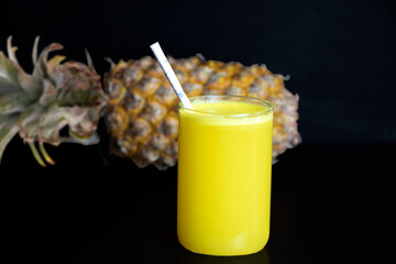 Fresh pineapple juice in a transparent glass.Selective focus