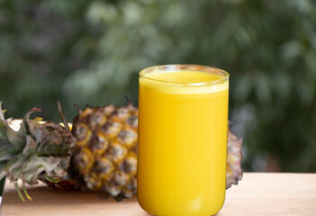 Fresh pineapple juice in a transparent glass.Selective focus