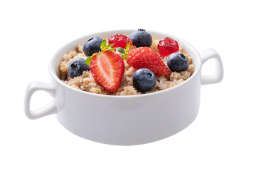 Buckwheat flakes with strawberries, blueberries and dried cherries in a ceramic white plate isolated on a white background