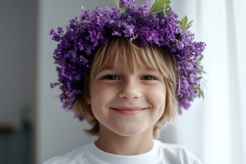 Fototapeta premium Morning rays. Happy caucasian child boy with blond hair wearing purple flower crown on his head. Happy holiday season holidays visual creative design art. Young traveler in nature.