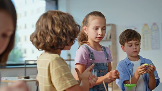 Pupils enjoy creativity art class creating colorful crafts closeup. School kids