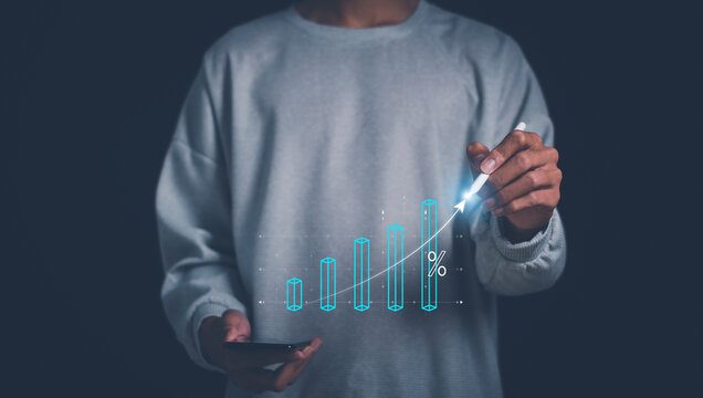 Hand holding graph with percentage, returns on investments,tax, adjusting interest rates, raising interest rates to fight inflation.