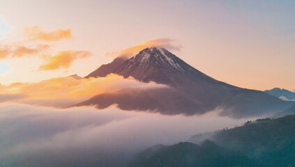 Scenic Mountain Peak Surrounded by Mist at Sunrise, Capturing Nature's Tranquility and Beauty