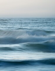 Fototapeta premium Gentle ocean waves in neutral tones with soft gradients