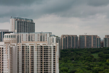 Gurgaon,Haryana,India city aerial view.Urban skyline of residential apartments,commercial hub during monsoon in Delhi NCR’s posh business locality.Gurugram cityscape with modern architecture.