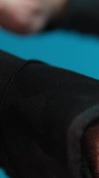 ugg boots cleaning black boots with brushes in the studio. Male brushing nubuck footwear with a small scrub brush. Theme of care for winter shoes. Washes dirty black fall booties, workshop shoes