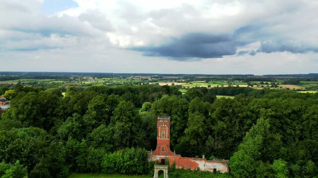 Ascending aerial footage of the Bosworth Hall Water Tower on a sunny day in Market Bosworth, UK