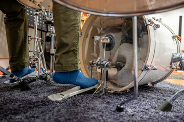 Person's foot playing kick drum in recording studio