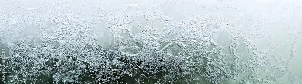 Aufkleber Detailed and intricate frost patterns covering a frozen surface creating a captivating and serene winter landscape  The delicate crystalline formations showcase the beauty of nature in a freezing