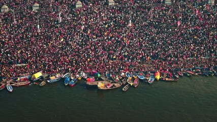 Aerial view of Huge crowd at Triveni Sangam in Prayagraj, India during Maha Kumbh. Kumbh Mela is the most important event, where millions of devotees, including Sadhu take a sacred holy dip in Ganga.