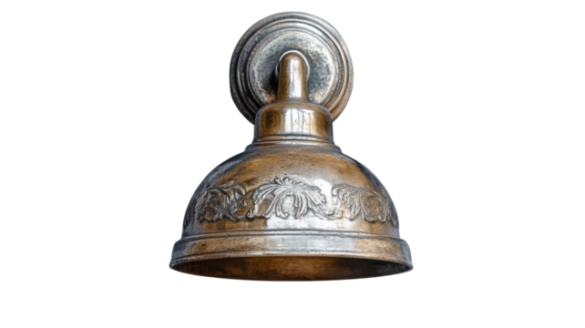 Decorative brass bell with intricate floral design mounted on a wall in a vintage setting