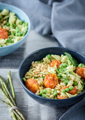 Avocado pesto pasta with peas, asparagus and roasted tomatoes