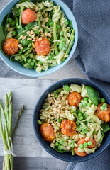 Avocado pesto pasta with peas, asparagus and roasted tomatoes