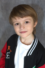 A handsome blond boy with big brown eyes in a sports jacket