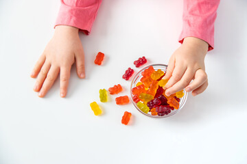 Child eating jelly candies at home. Selective focus.