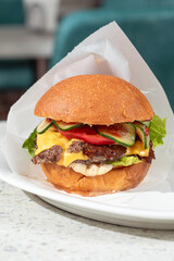 Portion of appetizing american cheeseburger on a plate