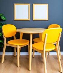 Round wooden table with four mustard yellow chairs against a dark gray wall. Two blank frames hang above the table. Natural light illuminates the