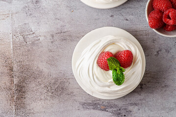 pavlova meringue dessert with raspberries and cream