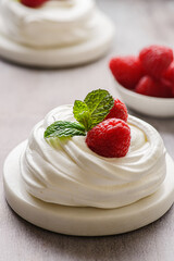 pavlova meringue dessert with raspberries and cream