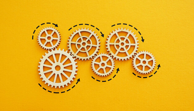 Symbolic gears as a metaphor for leadership transition and succession.
