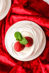 pavlova meringue dessert with raspberries and cream