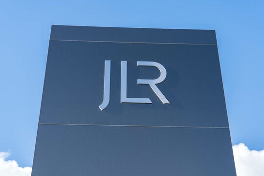 Wolverhampton, UK - February 22 2025: Jaguar Land Rover motor company logotype on a signage board outside of an engine factory