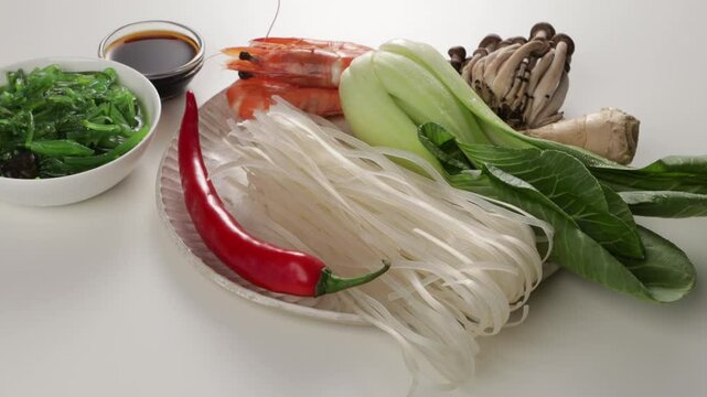 close up of fresh green chinese pak choi and other ingredients on light surface zoom food