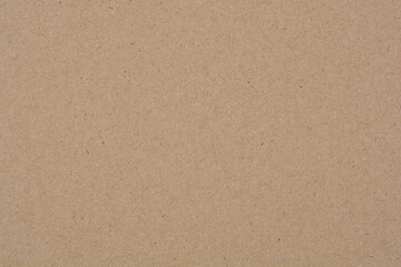 A close-up, flat lay shot of a plain brown paper surface, showcasing its texture and natural color