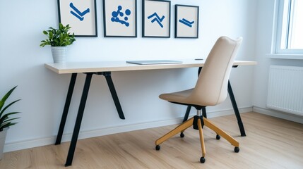 Beige chair at a minimalist white desk with blue framed wall art in a bright room. Light hardwood floors and a small plant add to the calming
