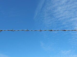 Galvanized barbed wire with four points per knot, preventing unauthorized access, especially in hazardous areas like high-voltage zone.