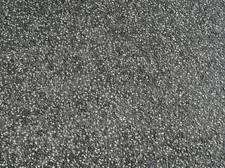 Asphalt road surface with white gravel ensures grip and safety. Interesting texture, ideal as a background or for road construction themes.