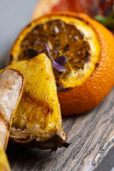 Slices of dried orange and grapefruit on a wooden board