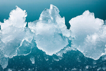 Majestic icebergs rise from a vast frozen landscape under a serene sky