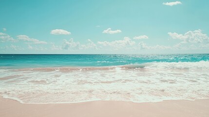 Fototapeta premium Serene Tropical Beach with Gentle Waves and Clear Blue Sky
