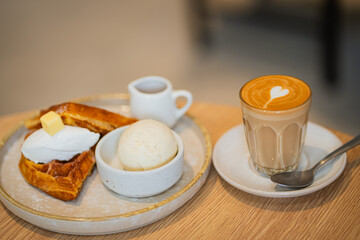 Coffee and desserts pastry, waffle and icecream on wooden table top, selected focus.