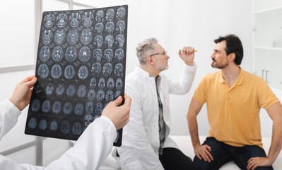 Male patient with headaches and migraines underwent MRI of brain and is consulting with hospital...