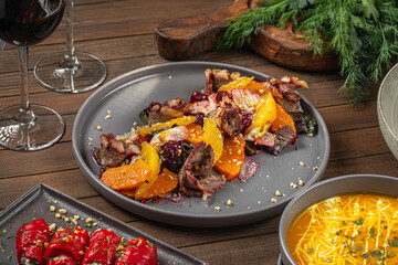 Portion of gourmet beef with pumpkin and beets on wooden table