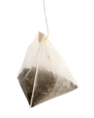 Hanging pyramid-shaped tea bag filled with loose tea leaves, mesh design, isolated on white background